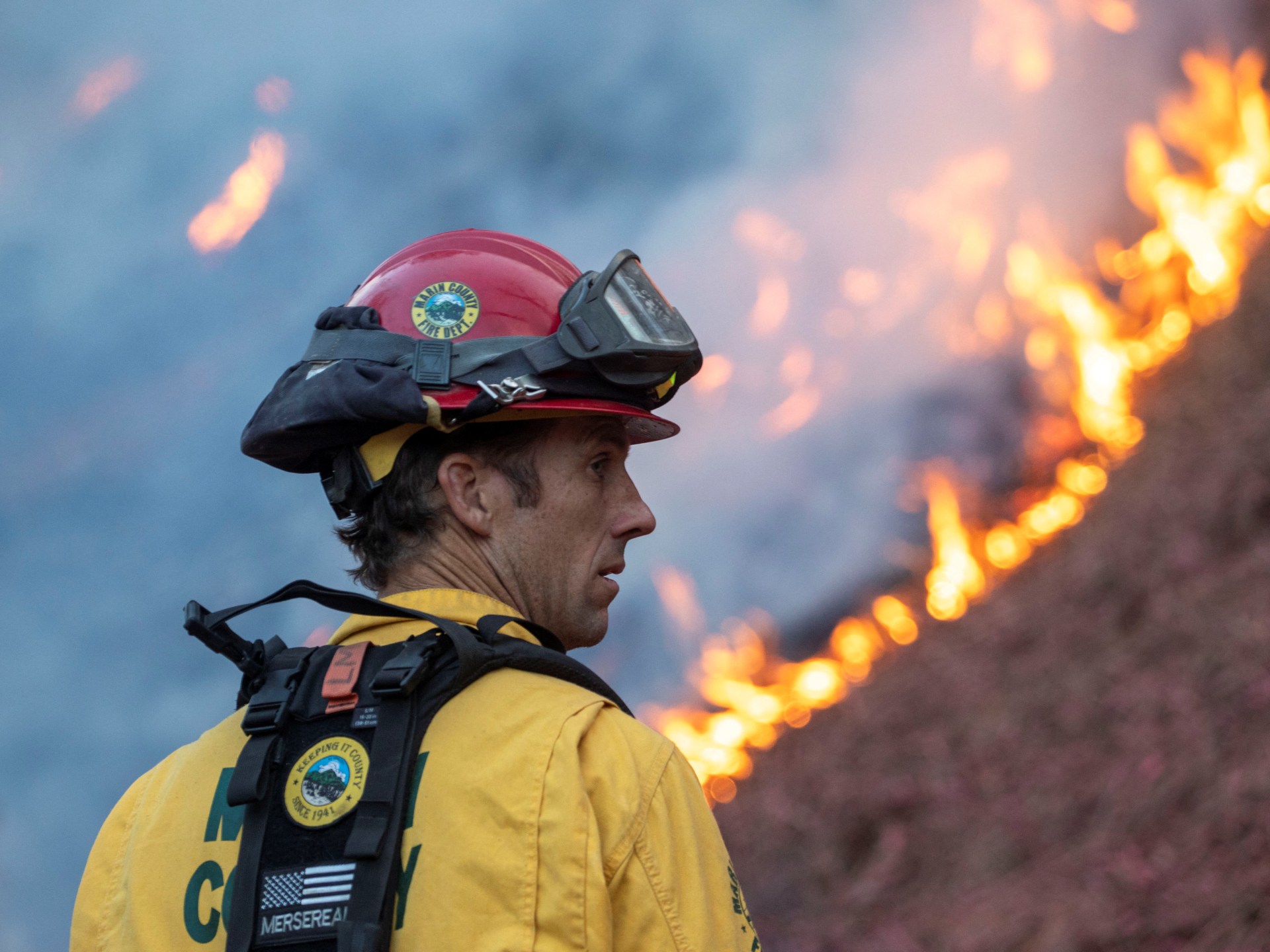 Firefighters battle to corral Los Angeles fires before strong winds return | Climate Crisis News