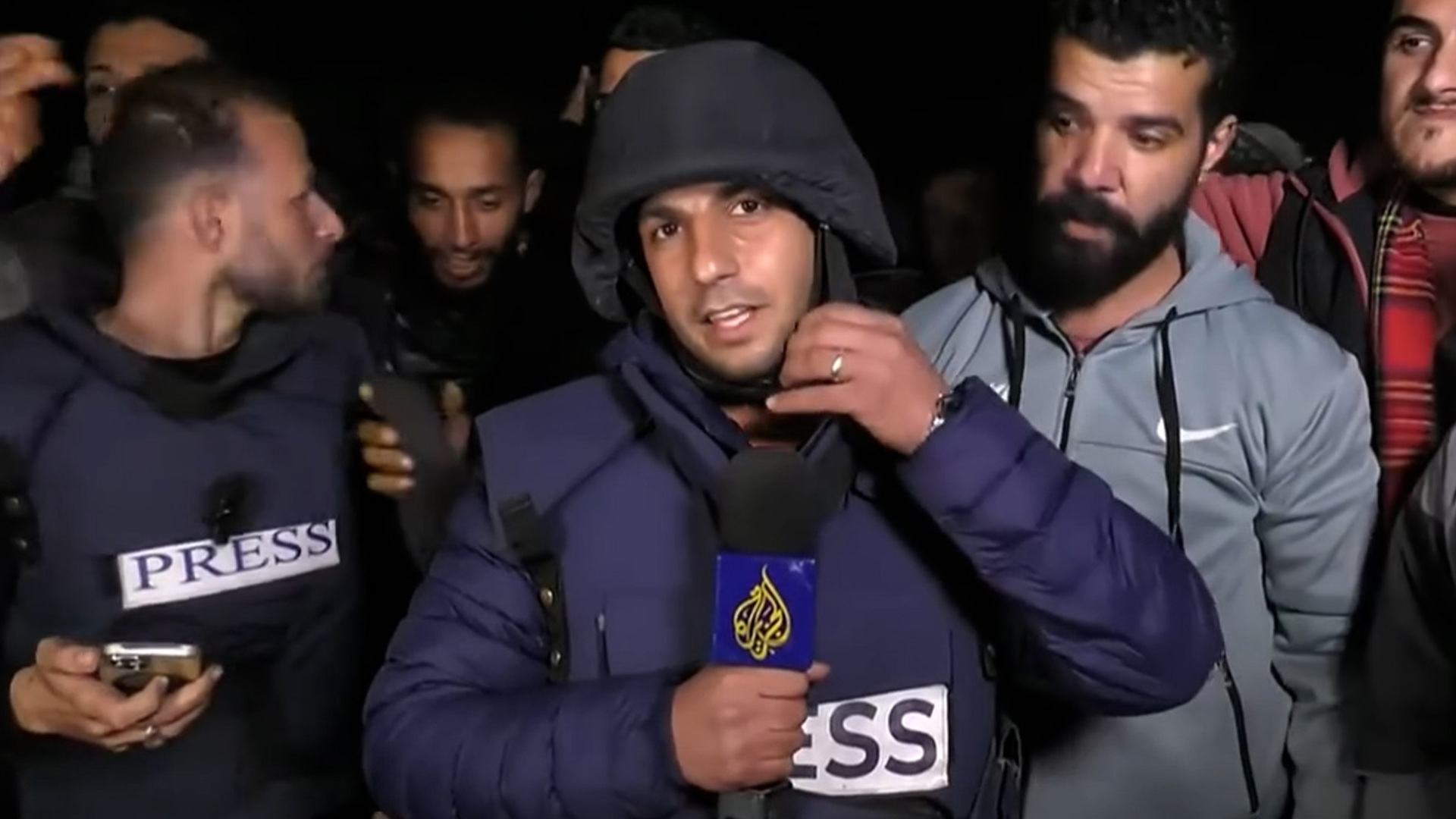 Al Jazeera reporter in Gaza removes protective gear